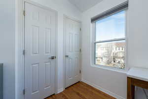 Unfurnished bedroom with dark hardwood / wood-style flooring