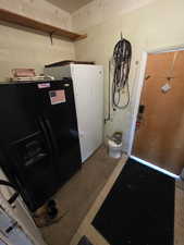 Kitchen featuring black fridge and refrigerator with ice dispenser