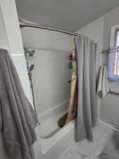 Bathroom with shower / bathtub combination with curtain