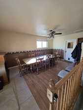 Tiled dining room featuring ceiling fan