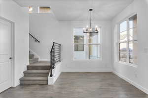 Interior space with an inviting chandelier and hardwood / wood-style floors