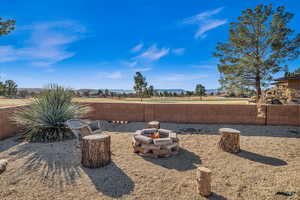 View of yard with an outdoor fire pit