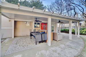 View of patio featuring ceiling fan and an outdoor living space