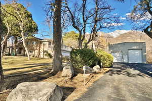 View of front of house with a garage, a mountain view, and a front yard