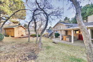 View of yard with a shed and a patio area