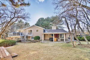 Back of property with a patio and a yard