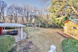 View of yard with a storage shed