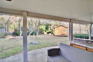 View of patio with a shed