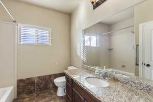 Full bathroom featuring vanity, shower / washtub combination, and toilet