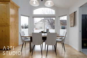 Dining area with plenty of natural light and light hardwood / wood-style flooring