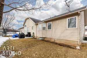 View of property exterior featuring a trampoline, a patio area, and a lawn