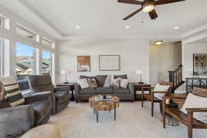 Living room featuring ceiling fan and light parquet flooring