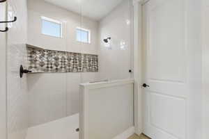 Bathroom featuring tiled shower