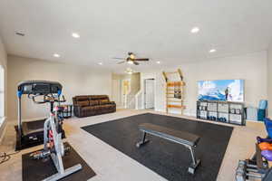 Workout room featuring light colored carpet and ceiling fan