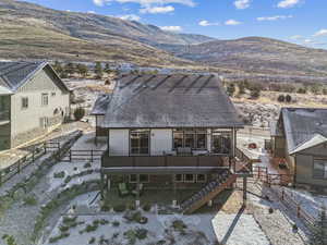 Rear view of property featuring a deck with mountain view