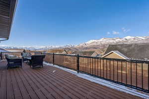 Snow covered deck featuring a mountain view