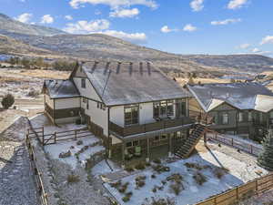 Exterior space with cooling unit and a deck with mountain view