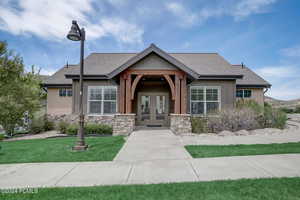 View of front facade featuring a front yard and french doors