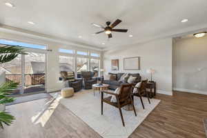 Living room featuring ceiling fan, a healthy amount of sunlight, and wood-type flooring