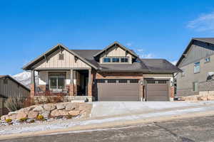 View of front of property featuring a garage and covered porch