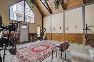 Workout room with wood ceiling and high vaulted ceiling