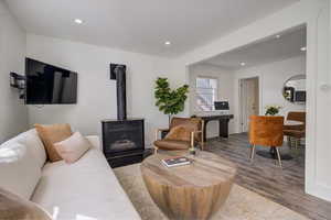 Living room featuring a wood stove and hardwood / wood-style floors