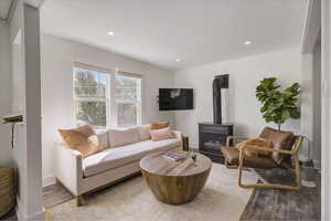 Living room with light hardwood / wood-style flooring and a wood stove