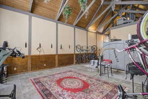 Playroom with beam ceiling, high vaulted ceiling, and wood ceiling