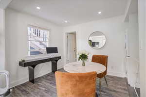 Dining room with dark hardwood / wood-style floors