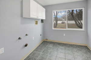 Laundry room featuring washer hookup, cabinets, and hookup for an electric dryer