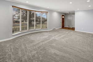 Carpeted empty room featuring crown molding