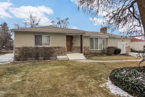 Ranch-style house with a front lawn