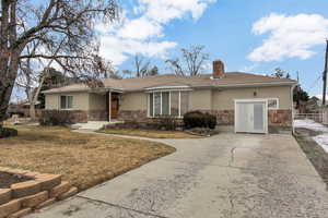 Single story home featuring french doors and a front lawn