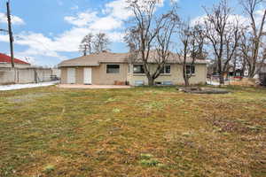 Back of house featuring a yard and a patio area