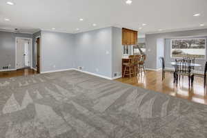 Unfurnished living room with ornamental molding and light hardwood / wood-style floors