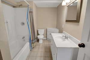 Full bathroom featuring tile patterned flooring, vanity, shower / tub combo, and toilet