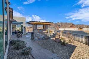 Exterior space with exterior kitchen, a fenced backyard, and a mountain view