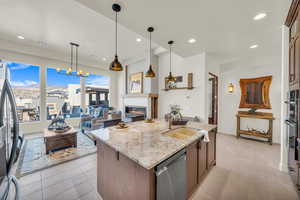 Kitchen with an island with sink, a sink, recessed lighting, and stainless steel appliances