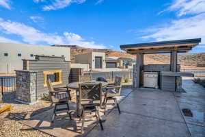 View of patio with outdoor dining space, fence, and a mountain view