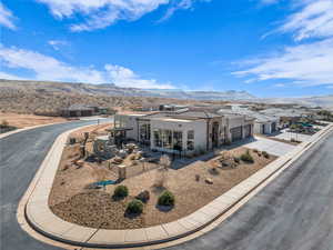 View of front of property with a garage, stucco siding, a tile roof, a mountain view, and concrete driveway