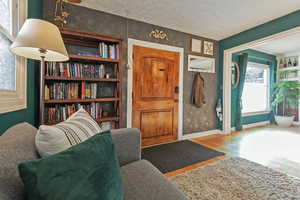 Interior space with hardwood / wood-style floors and a textured ceiling