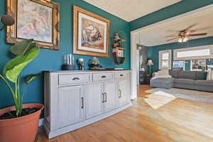 Hall featuring light hardwood / wood-style flooring and a textured ceiling