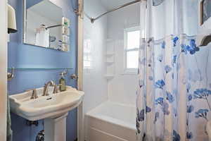 Bathroom featuring sink and shower / tub combo