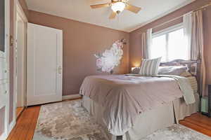 Bedroom with ceiling fan and light hardwood / wood-style floors