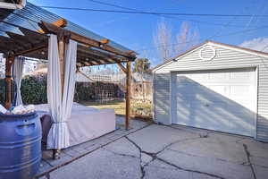 View of patio with a garage and an outdoor structure