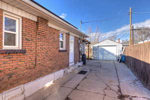 View of property exterior with a garage and an outdoor structure