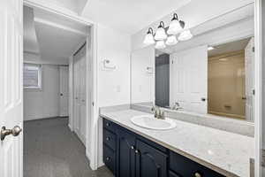 Bathroom featuring vanity, tiled shower / bath combo, and a textured ceiling