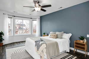 Bedroom featuring ceiling fan and dark hardwood / wood-style flooring