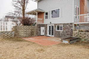 Rear view of property featuring a yard and a patio area