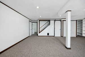 Basement featuring carpet floors and a textured ceiling